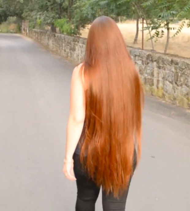 VIDEO - Thigh length hair lady walking outside