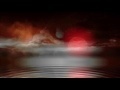 00187_night sky with large moon over water with mist seamless loop animation