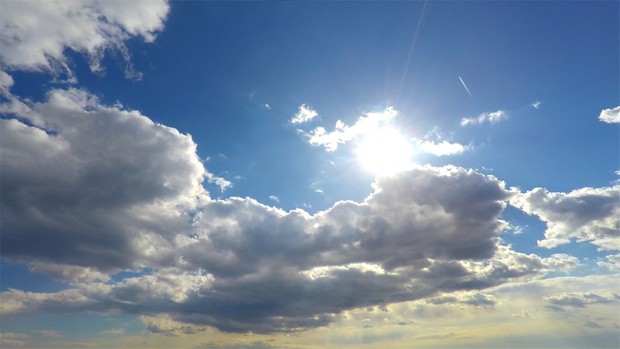 4K blue sky with clouds and sun wallpaper background